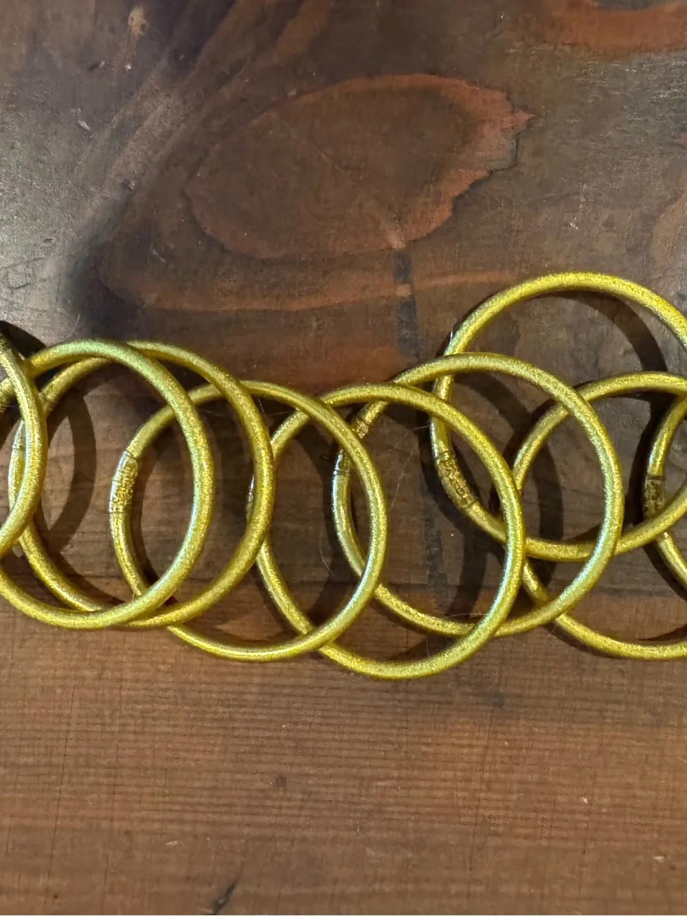 Set of 9 gold plastic glitter bracelets
